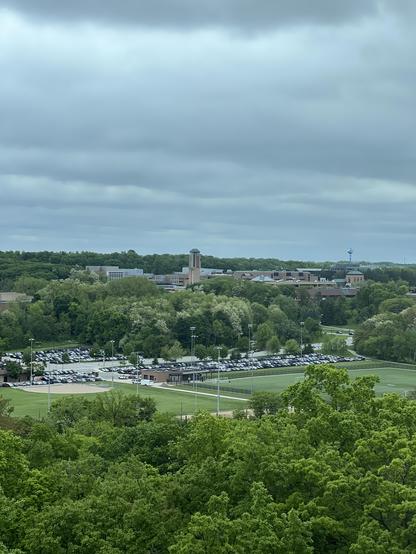 North Campus of the University of Michigan, photographed from the UM medical campus. Mitchell Field athletic fields and Fuller Rd are in the foreground. It’s cloudy.