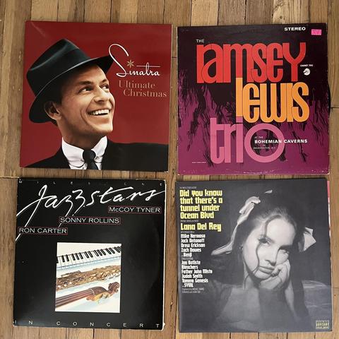 This image shows four album covers.

Frank Sinatra - "Ultimate Christmas".

The Ramsey Lewis Trio - "At The Bohemian Caverns" (live album).

Jazzstars - "Concert" featuring McCoy Tyner, Ron Carter, and Sonny Rollins.

Lana Del Rey - "Did You Know That There's A Tunnel Under Ocean Blvd".
