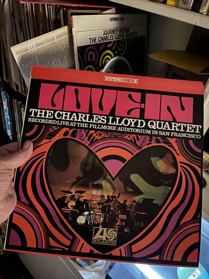 This photo shows another Charles Lloyd Quartet album, this time a live recording titled "The Charles Lloyd Quartet Recorded Live at the Fillmore Auditorium in San Francisco." It's also on Atlantic Records and marked as stereo.

The album cover features similarly psychedelic 1960s artwork with vibrant concentric circles and swirling patterns in hot pink, orange, and black. The design forms a heart-like or double-circle shape in the center, which contains a photograph of the quartet performing li…