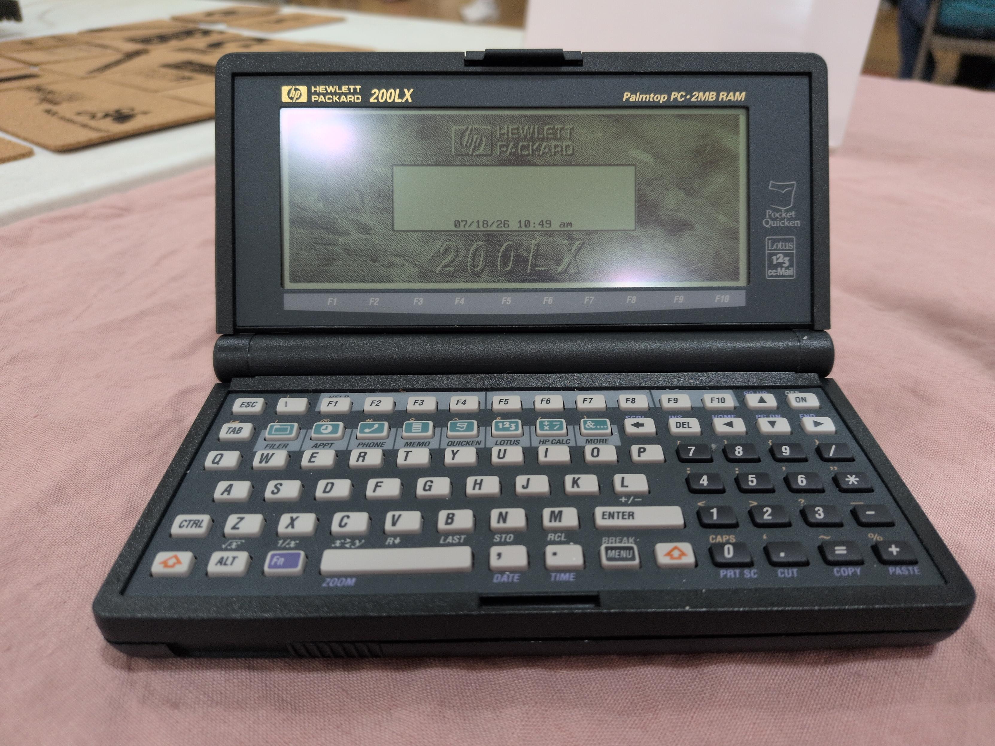 A closeup of the HP 200 LX, showing the screen and keyboard, on its home screen after booting.